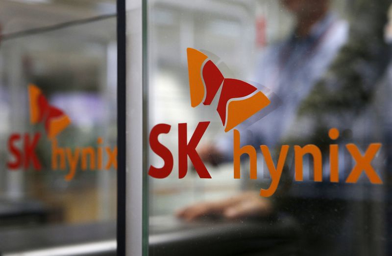 FILE PHOTO: Employee walks past the logo of SK Hynix
