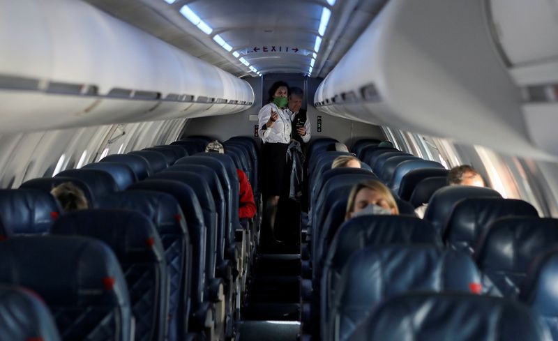 FILE PHOTO: Flight attendants talk in a nearly empty cabin