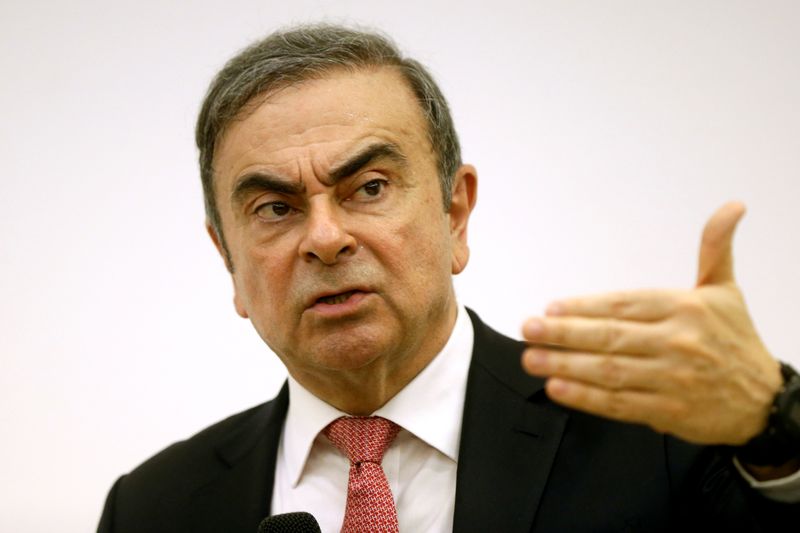 Former Nissan chairman Carlos Ghosn gestures during a news conference