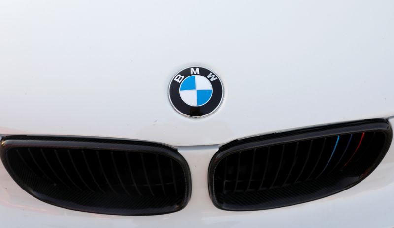 A BMW logo is seen on a car at the