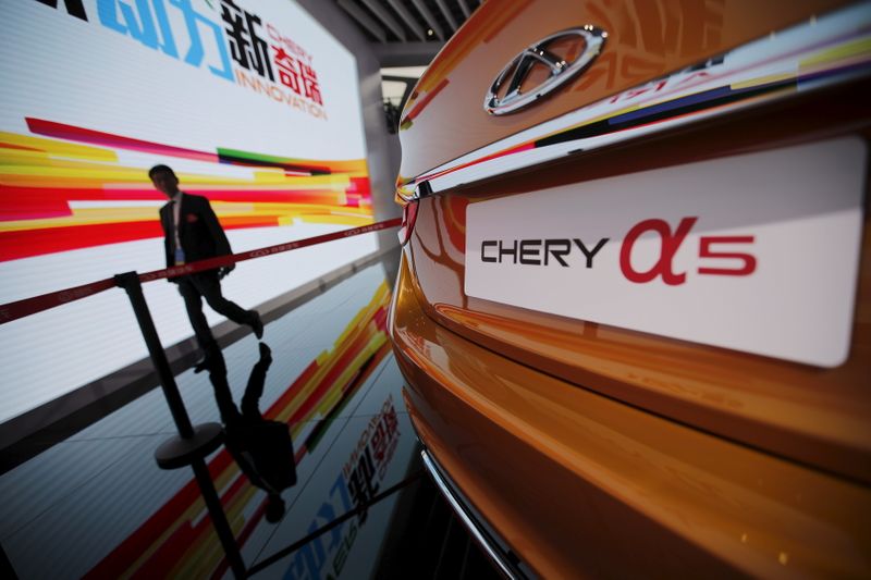 FILE PHOTO:  A visitor walks next to a Chery