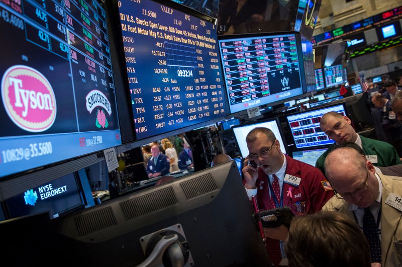 Traders gather at the post that trades Tyson Foods on