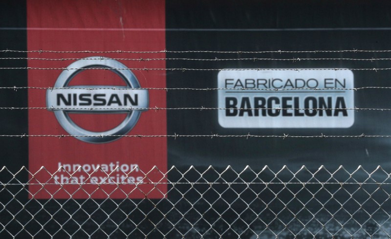 FILE PHOTO:  The logo of Nissan is seen through
