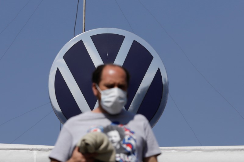 An employee leaves the Volkswagen (VW) plant as the company