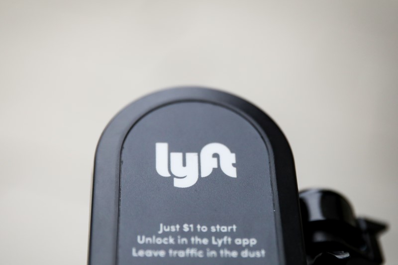 The Lyft  logo is seen on a parked Lyft