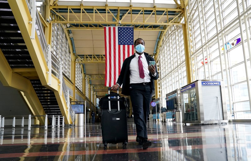 FILE PHOTO: Passenger walks through Reagan National airport as air