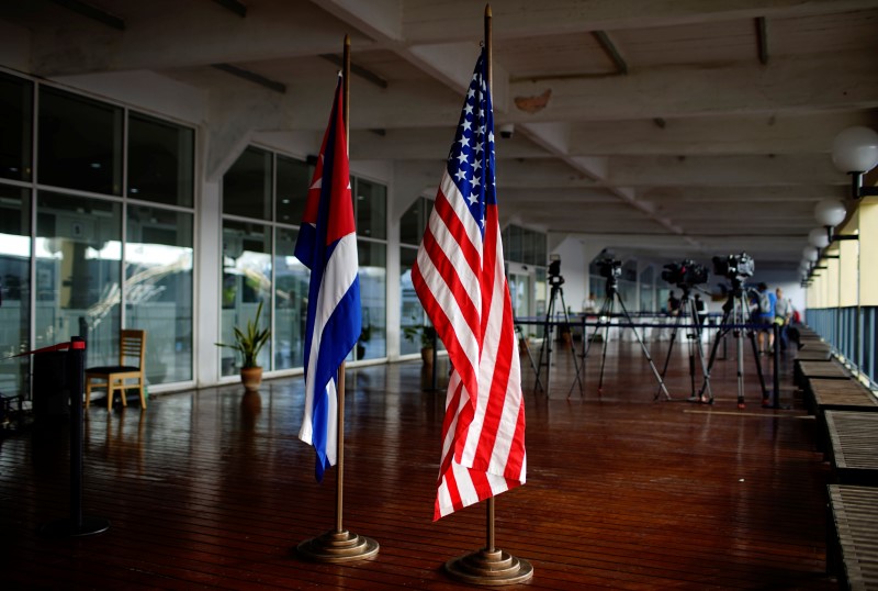 U.S. and Cuban flags are seen before a ceremony for