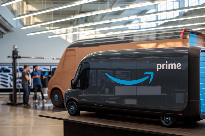 Models of the Rivian-built Amazon electric delivery vans are seen