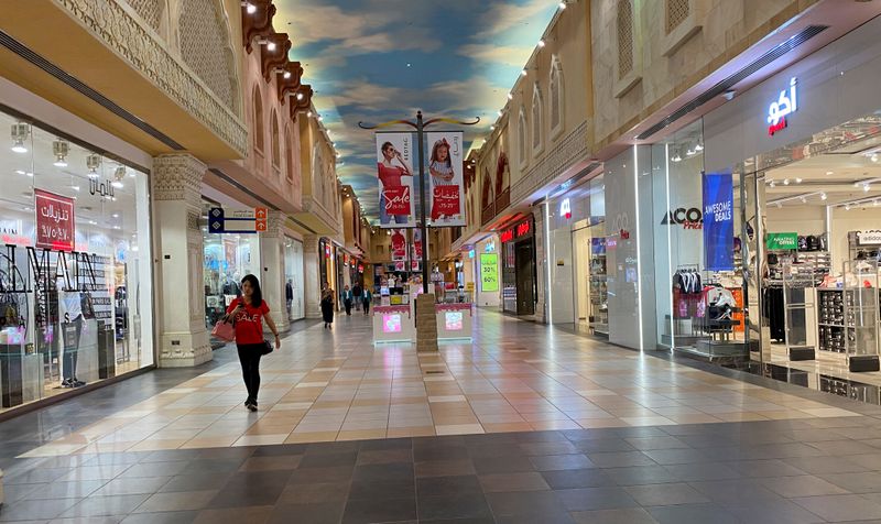 FILE PHOTO: A woman walks in an almost empty mall