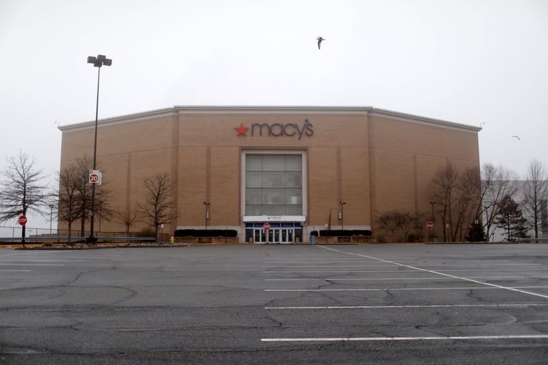 A shuttered Macy’s store and empty parking lot are seen