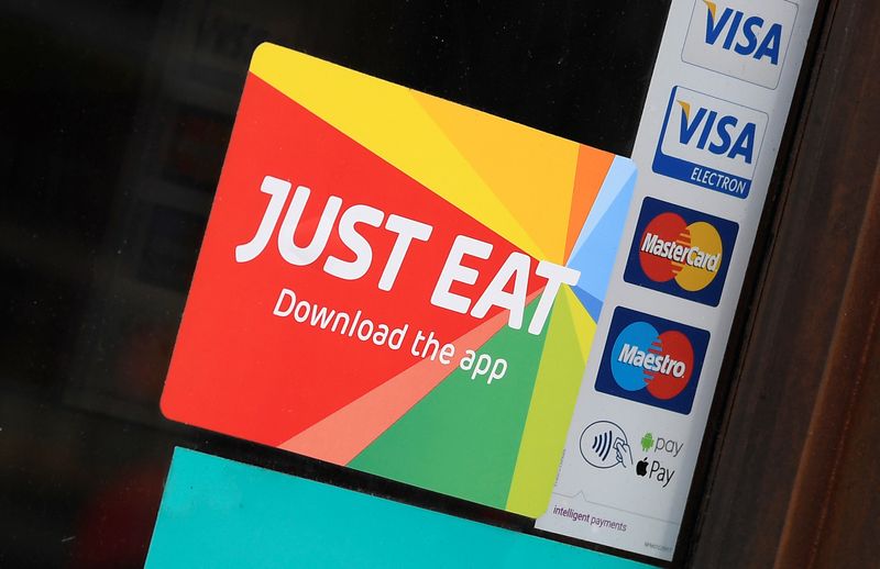 Signage for Just Eat is seen on the window of