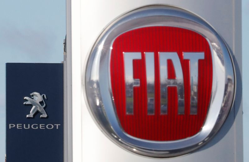 The logos of car manufacturers Fiat and Peugeot are seen
