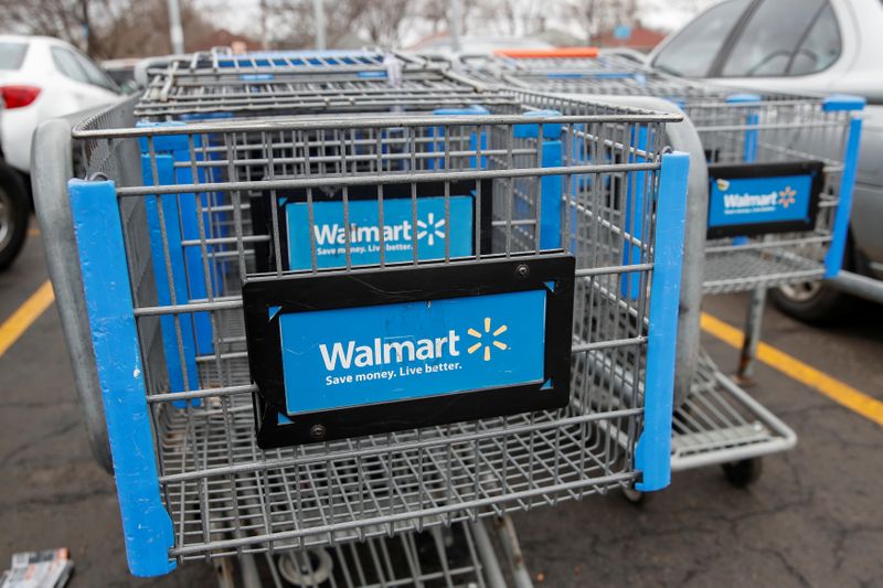 Walmart shopping carts are seen on the parking lot ahead