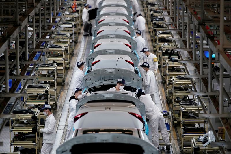 FILE PHOTO: Employees work on a production line inside a
