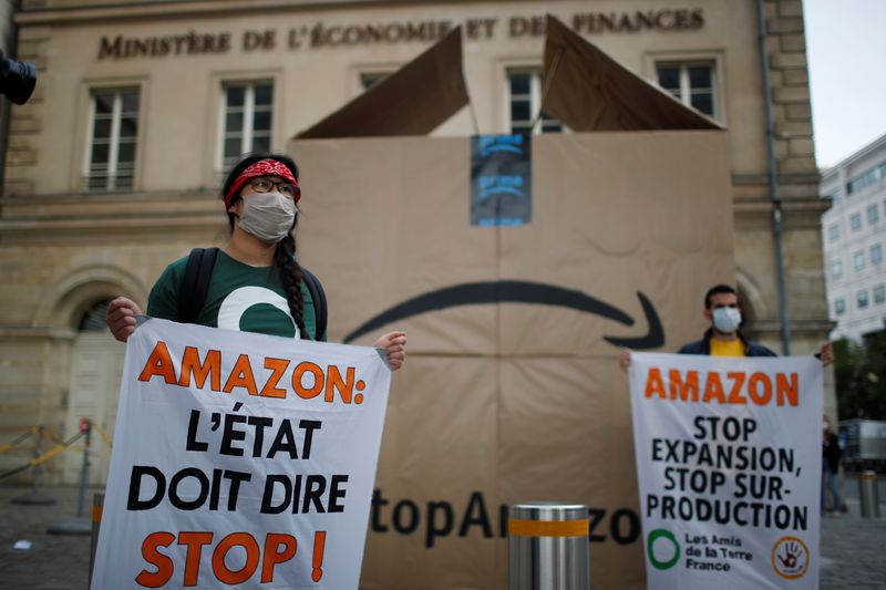 Climate activists attend a demonstration against Amazon near the Bercy