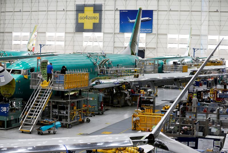 FILE PHOTO: People work near the door of a 737