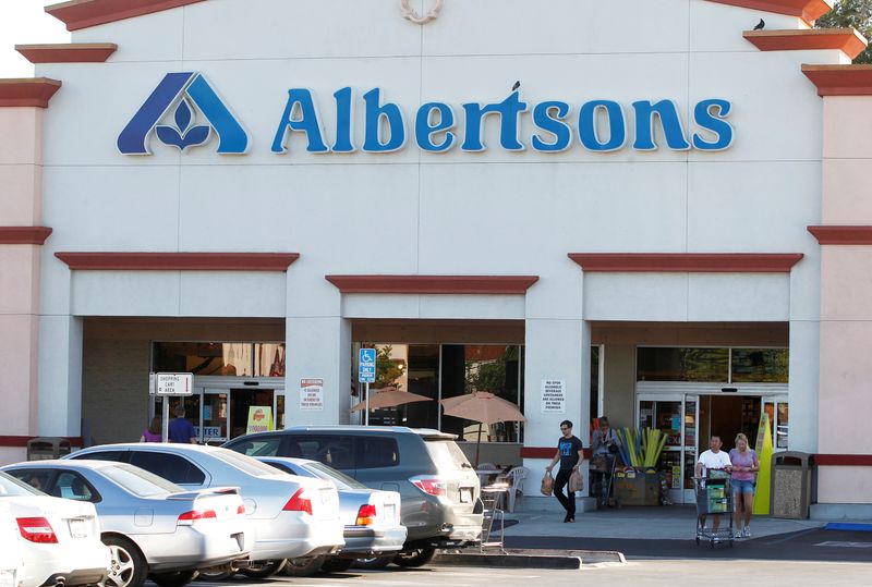 Customers leave an Albertsons grocery store with their purchases in