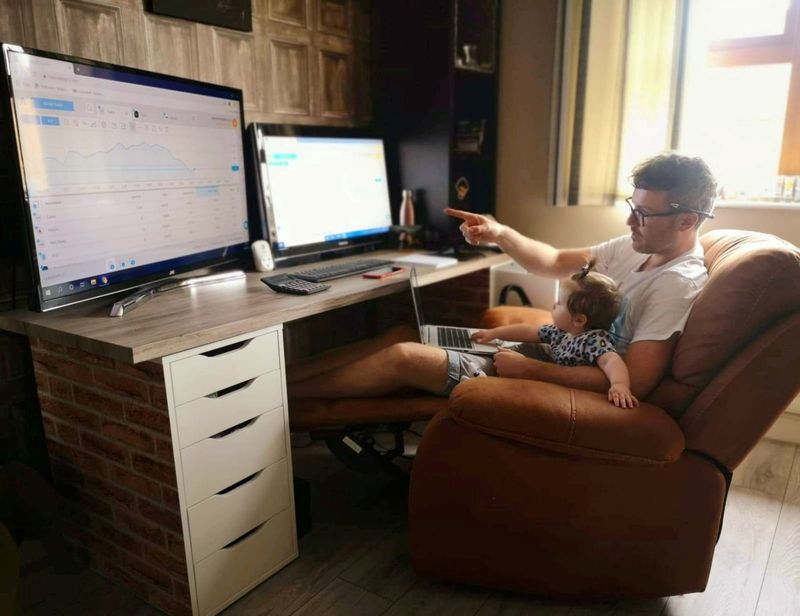 Daytrader Rachael McVeigh sits in front of computers with his