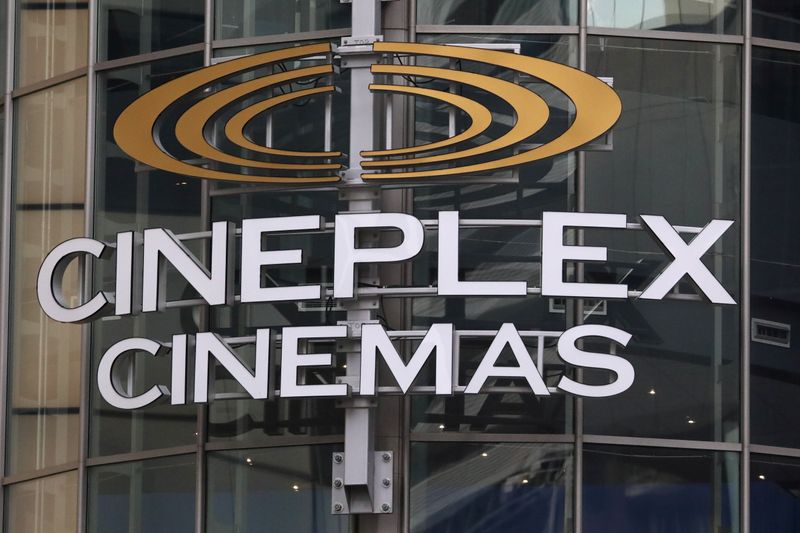 A Cineplex movie theatre sign looms over Yonge street in