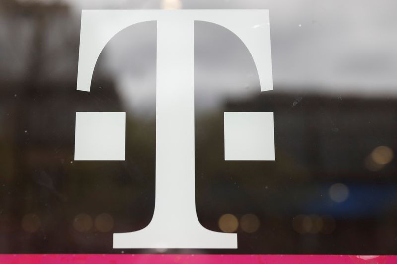 A T-Mobile logo is seen on the storefront door of