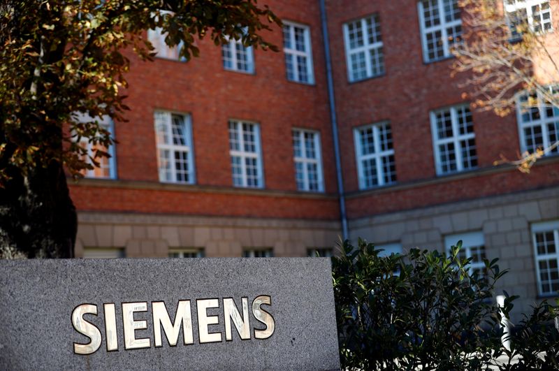 The Siemens logo is seen near a building in Siemensstadt