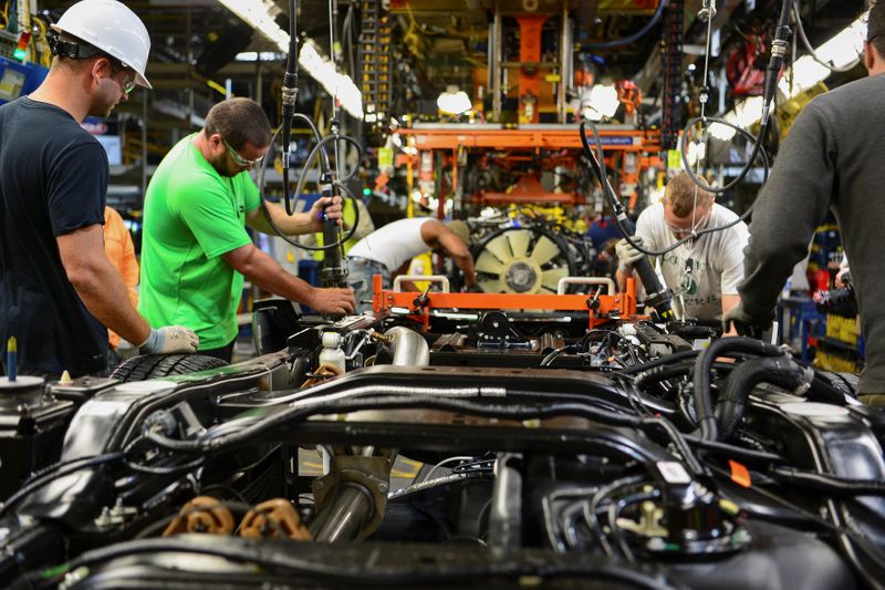 Workers assemble a Ford truck at the new Louisville Ford