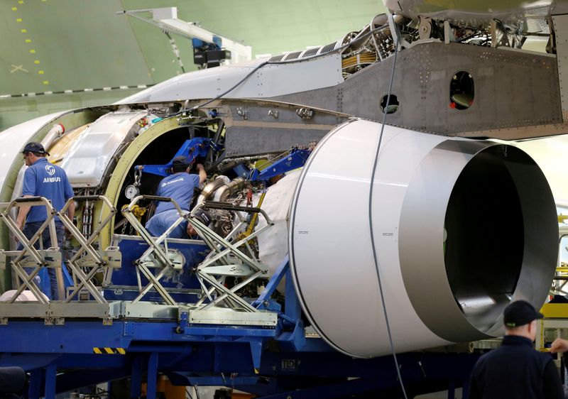 FILE PHOTO: Employees work on an engine of Airbus Beluga