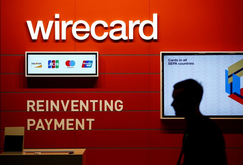 FILE PHOTO: A man walks past the Wirecard booth at