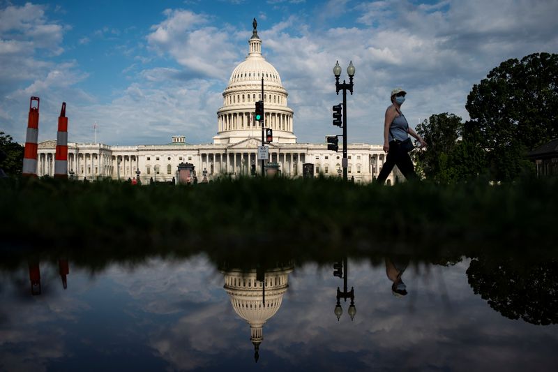 A woman walks past the U.S. Capitol building in Washington