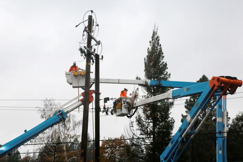 PG&E crew work on power lines to repair damage caused