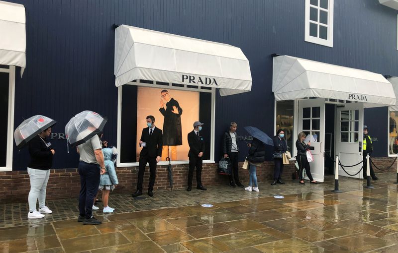 FILE PHOTO: Shoppers are seen queuing outside the Prada shop