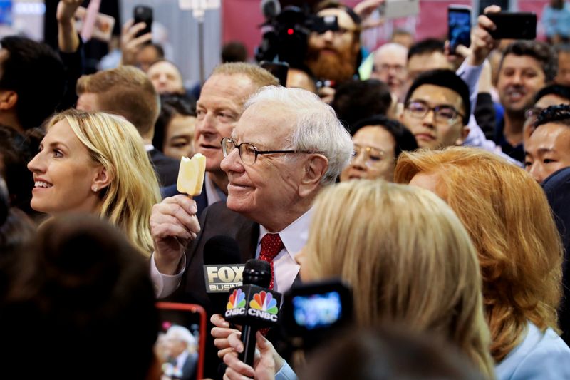 Berkshire Hathaway Chairman Warren Buffett walks through the exhibit hall