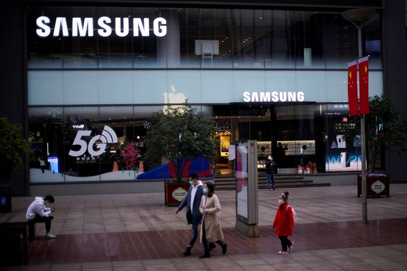 FILE PHOTO: People wear masks in front a Samsung store