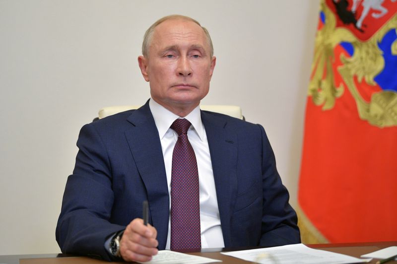 Russian President Vladimir Putin takes part in a a video