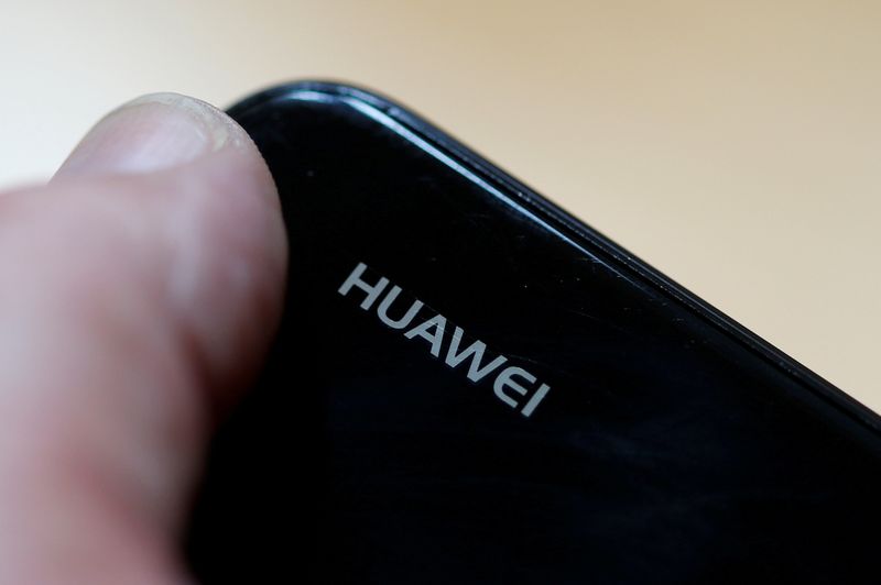 FILE PHOTO: A worker refurbishes a Huawei cell phone at