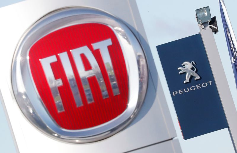 The logos of car manufacturers Fiat and Peugeot are seen