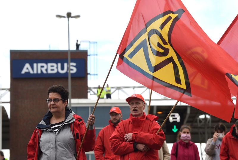 Airbus employees protest against the planned reduction of jobs in