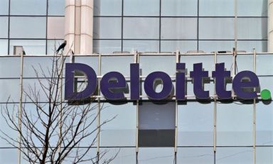 The Deloitte Company logo is seen on a commercial tower