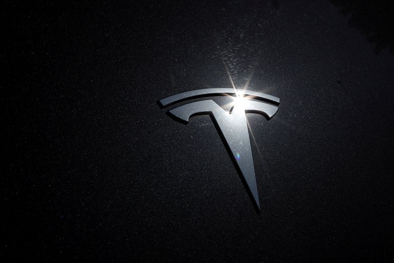 The Tesla logo is seen on a car in Los