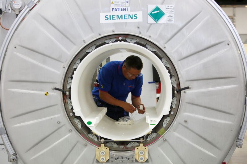 A staffer works on a magnetic resonance imaging machine at