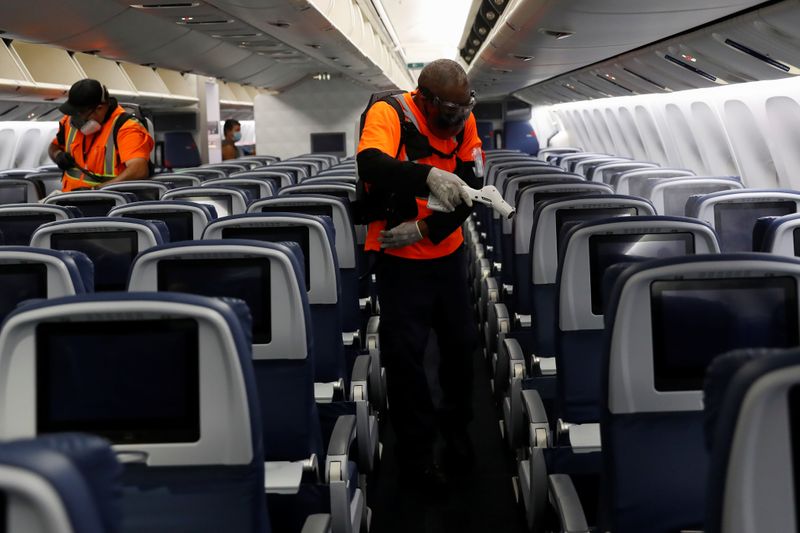 Delta Airlines pre-flight cleaning crew members use electrostatic disinfection devices