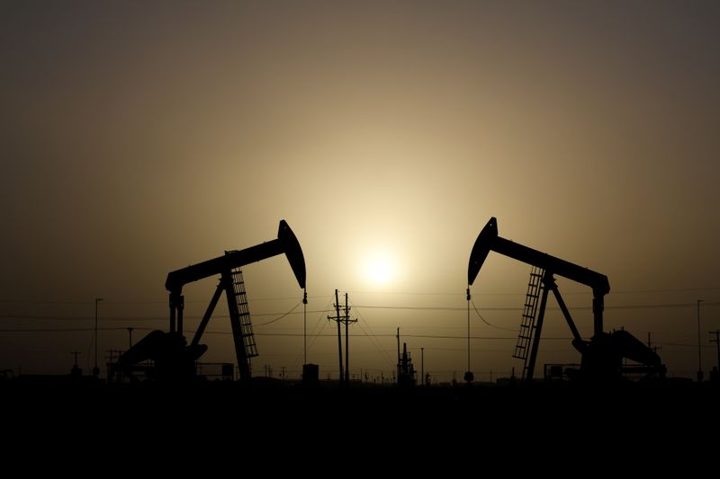 FILE PHOTO: Pump jacks operate at sunset in Midland