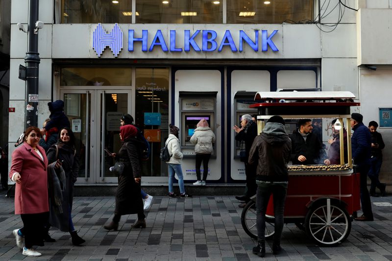 People walk past by a branch of Halkbank in central