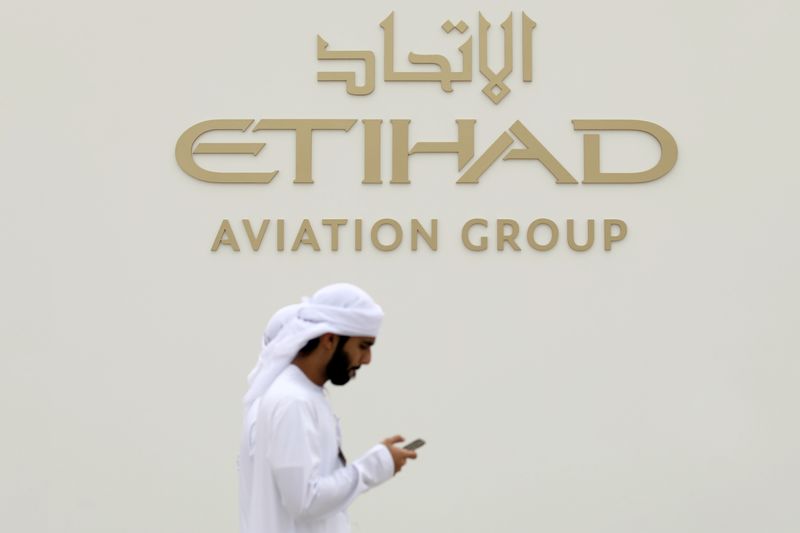 FILE PHOTO: A visitor walks past the Etihad Aviation Group