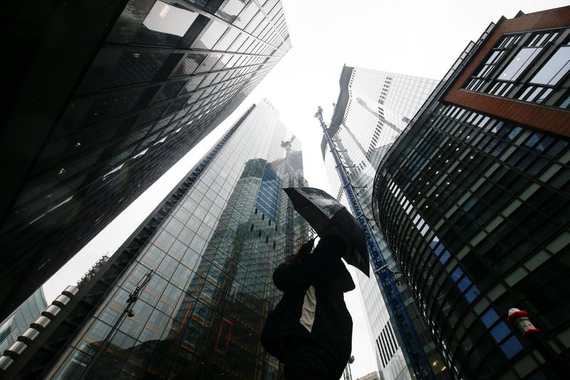 FILE PHOTO: A person walks through the financial district during