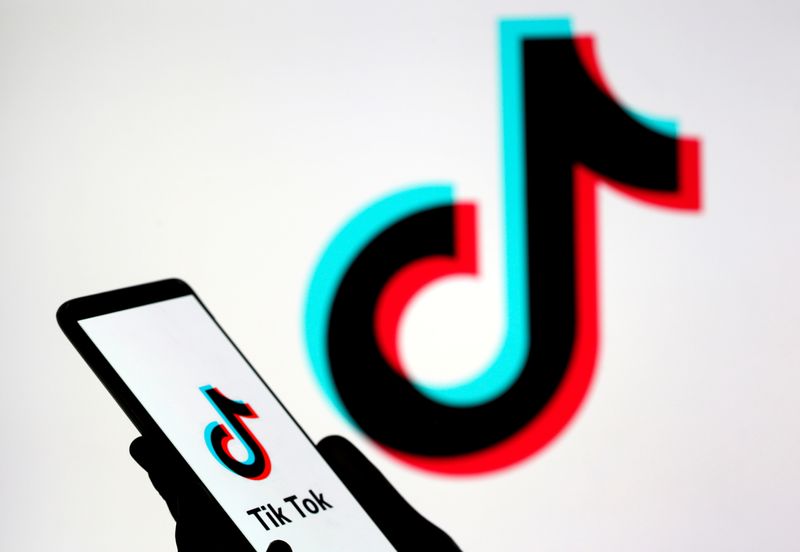 FILE PHOTO: A person holds a smartphone with TikTok logo