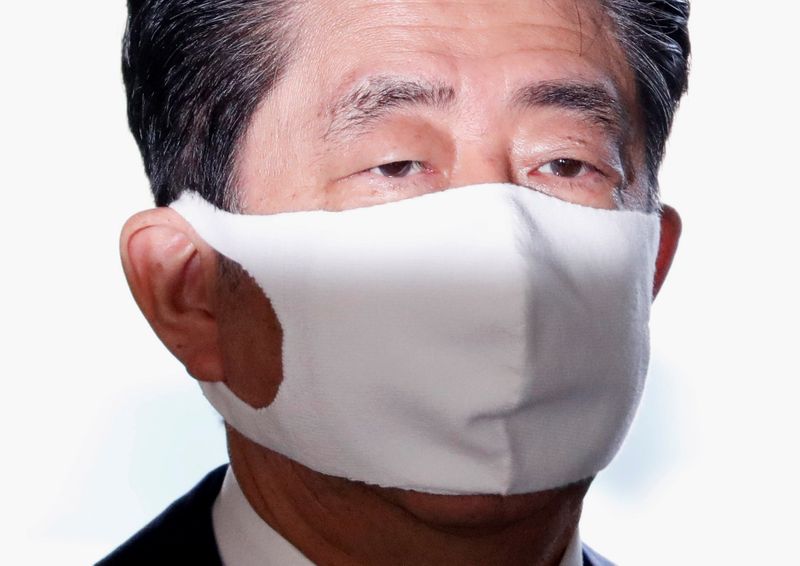 Japan’s Prime Minister Shinzo Abe wearing a protective face mask