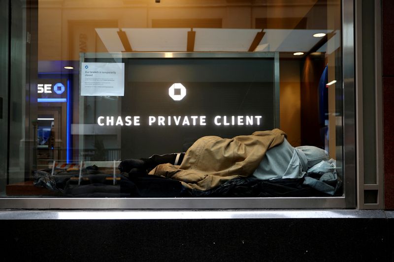 FILE PHOTO: A homeless man sleeps in a closed Chase