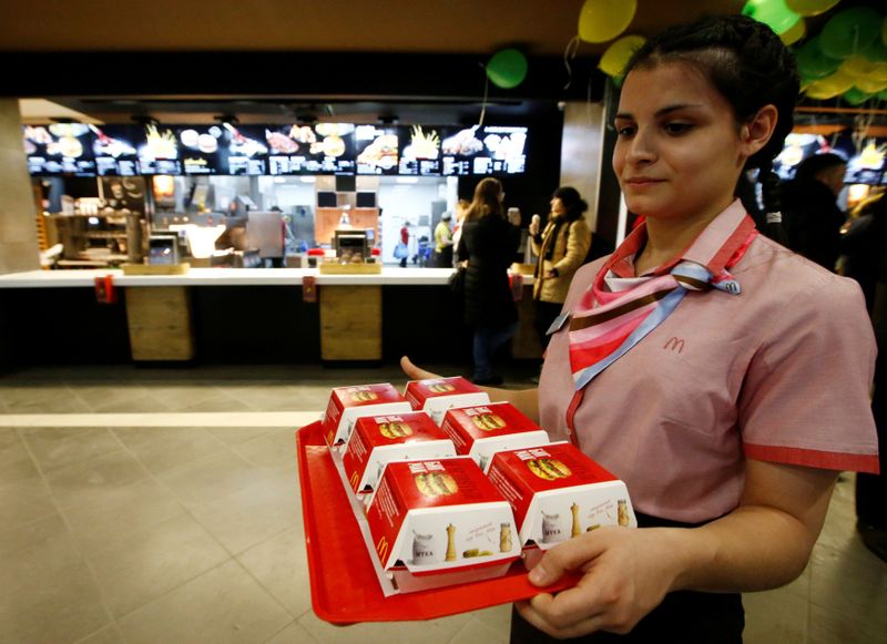 FILE PHOTO: McDonald’s employee holds tray of Big Mac burgers