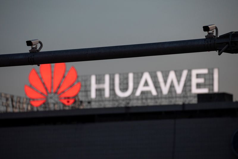 Surveillance cameras are seen in front of a Huawei logo